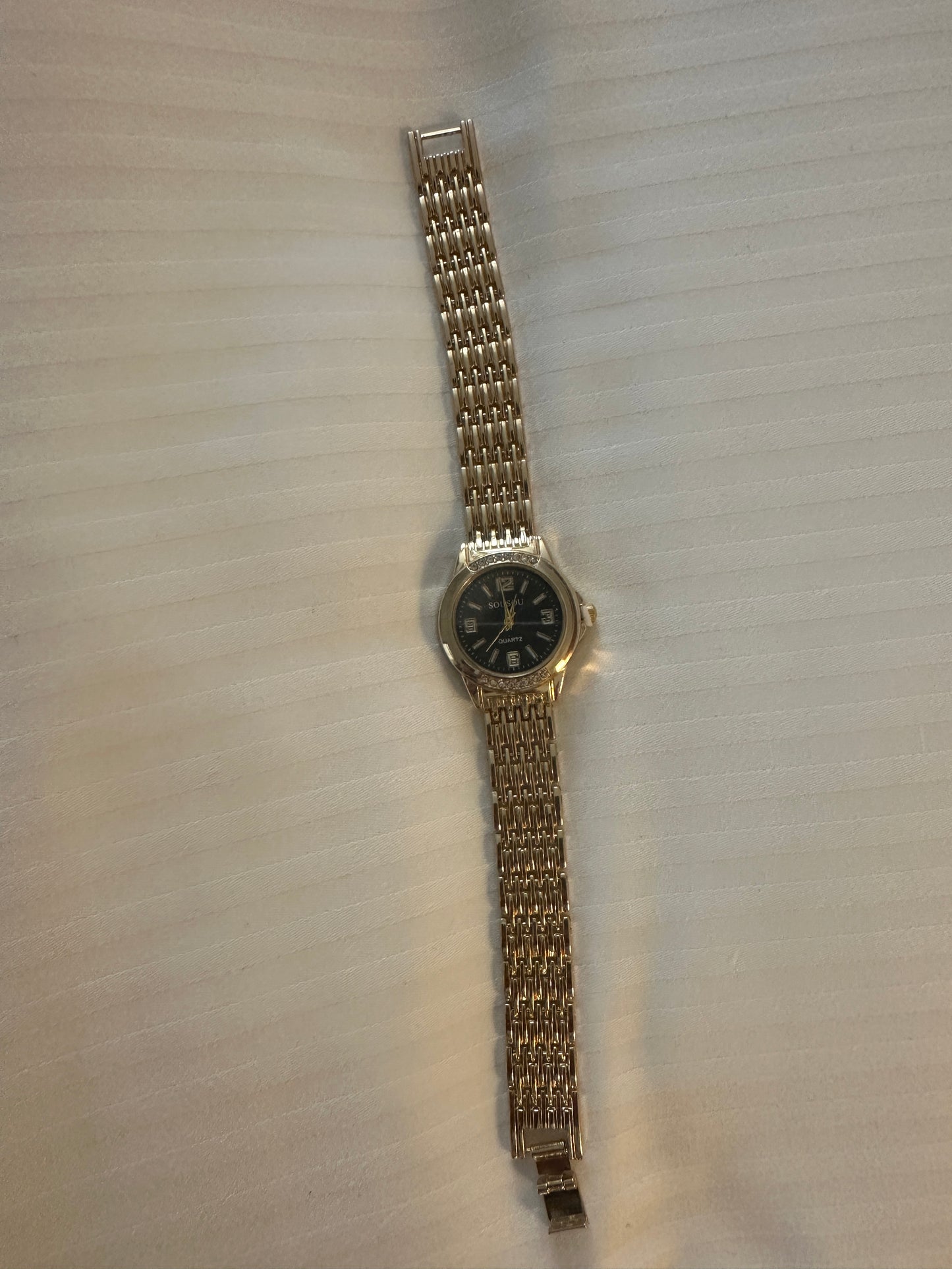 Gold and black strap watch