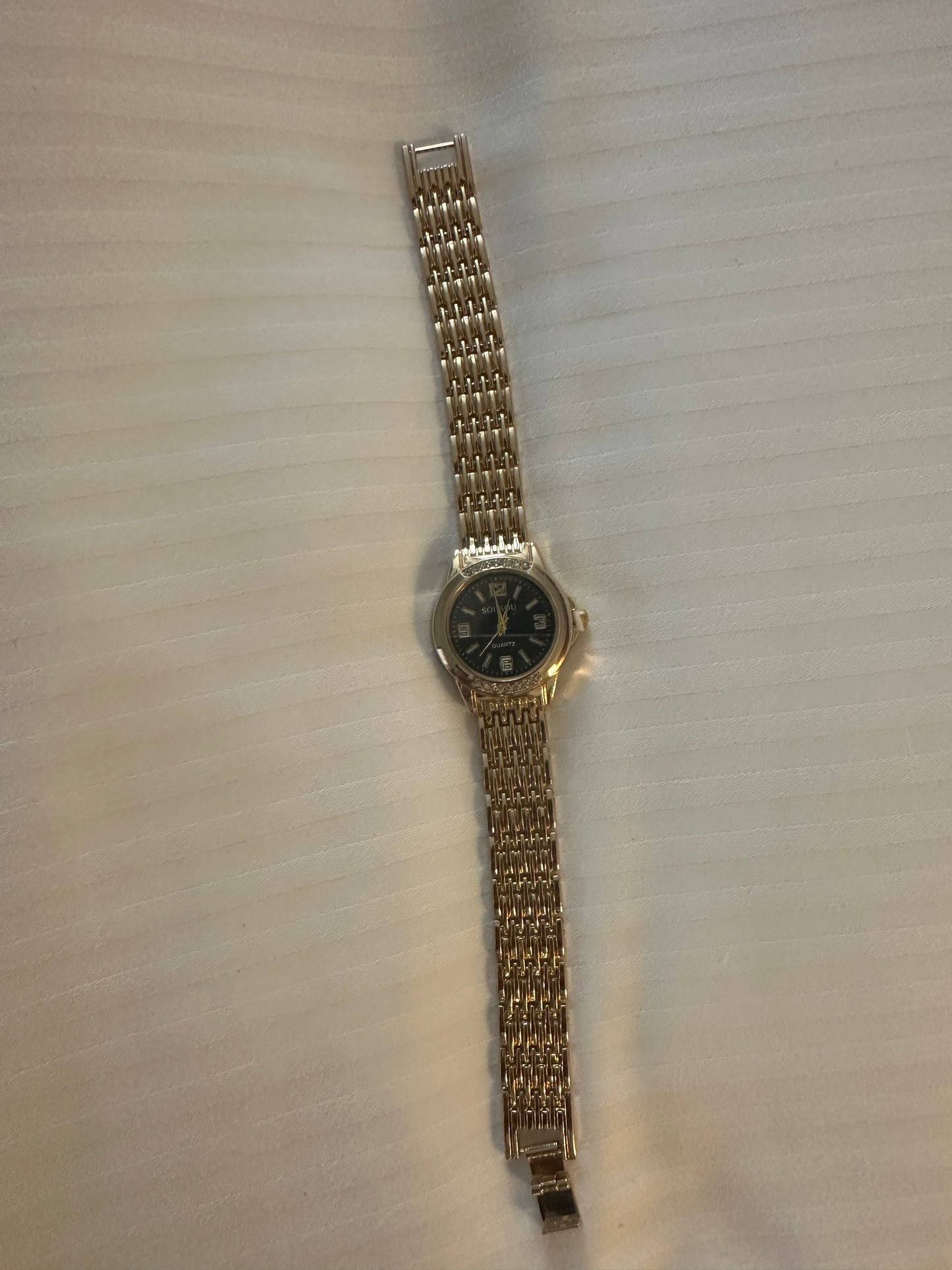 Gold and black strap watch