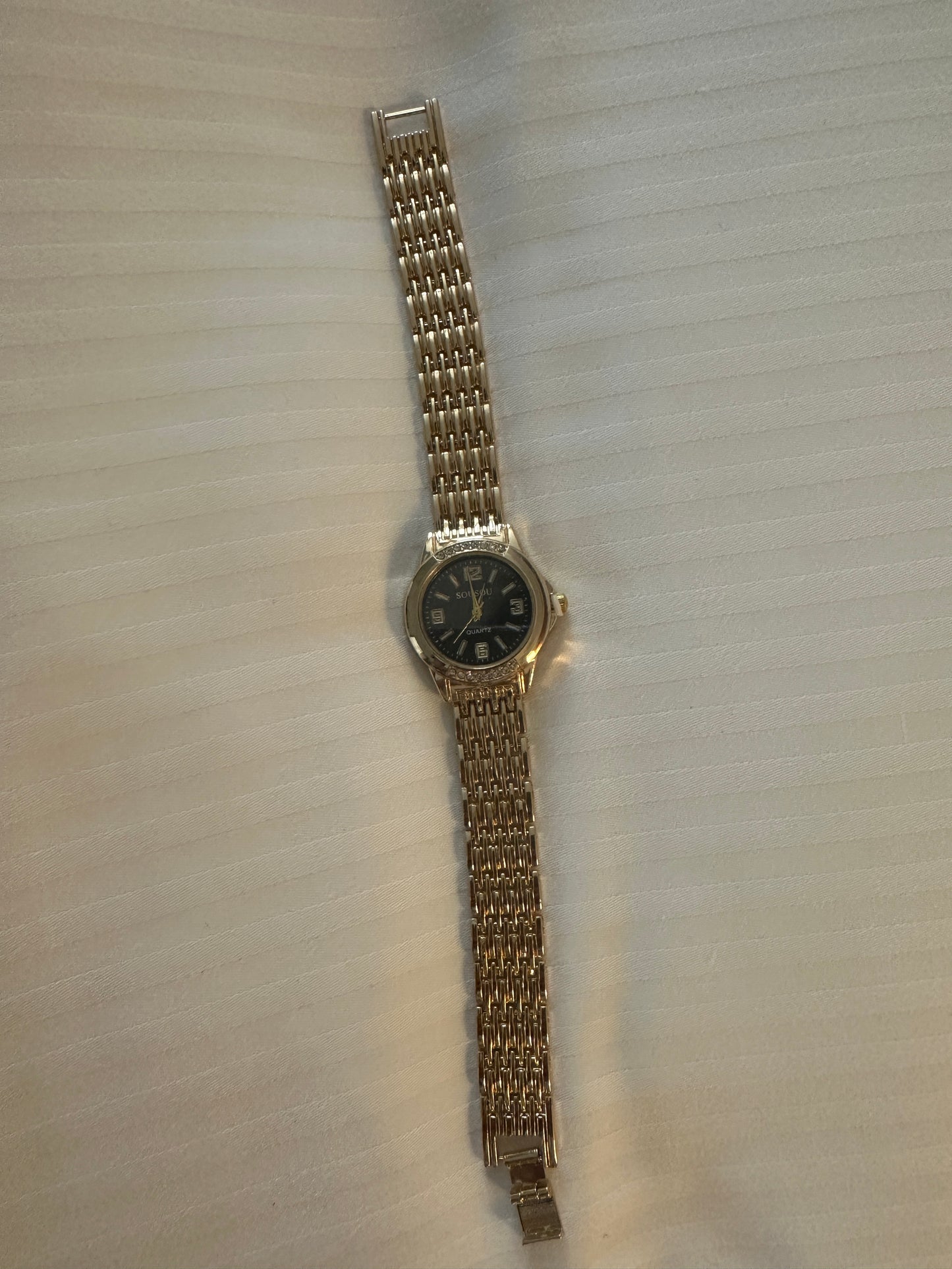 Gold and black strap watch